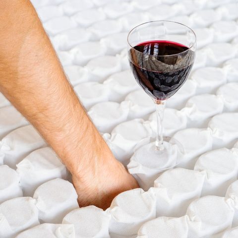 A wine glass balances steadily on the pocket springs